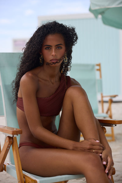 Woman sitting on a beach chair at the beach