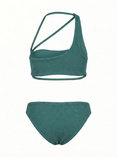 green bikini set with a wrap-design top and bikini bottom on a white background